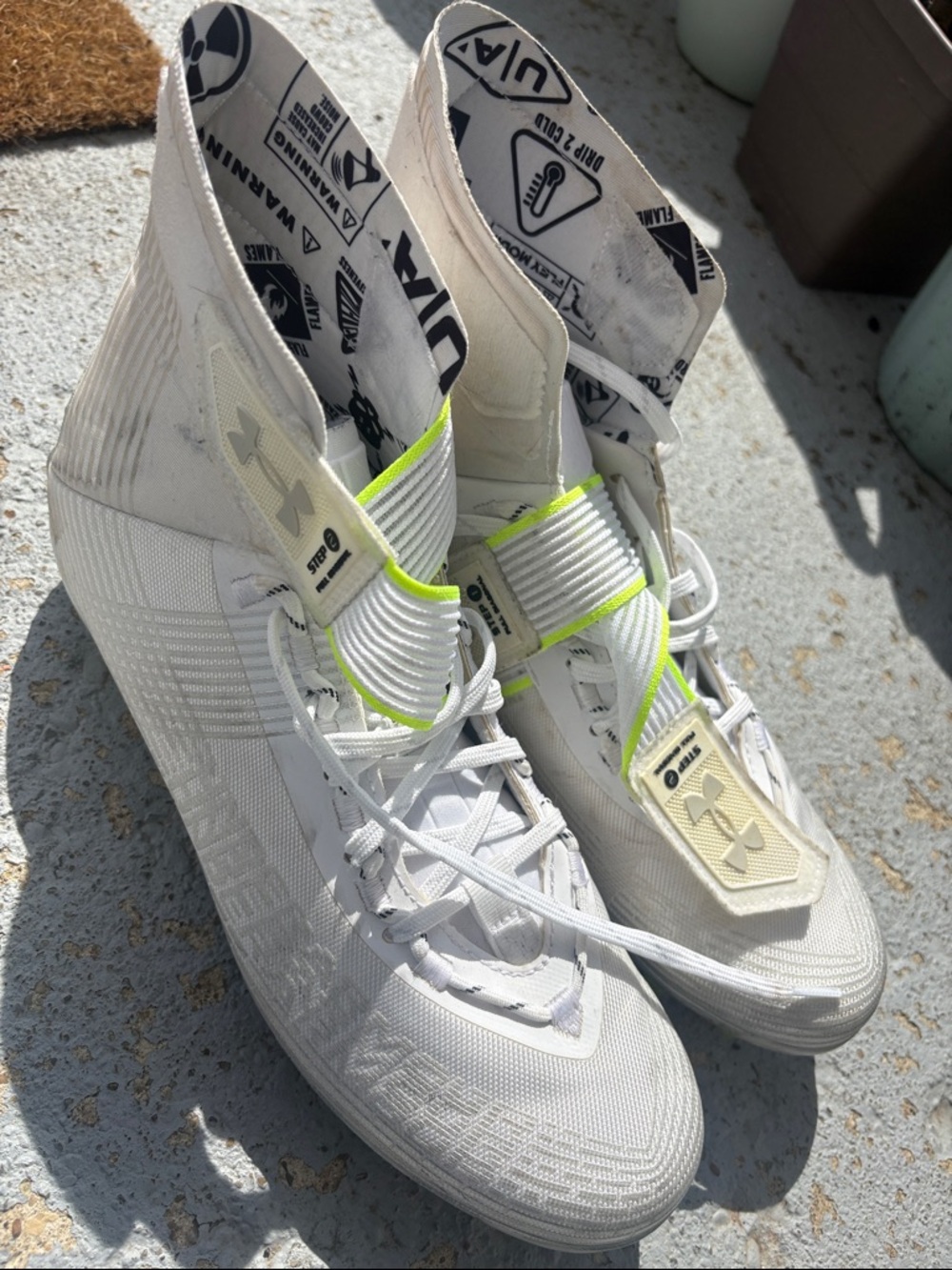 Under Armour White High-Top Football Cleats with Neon Yellow Accent